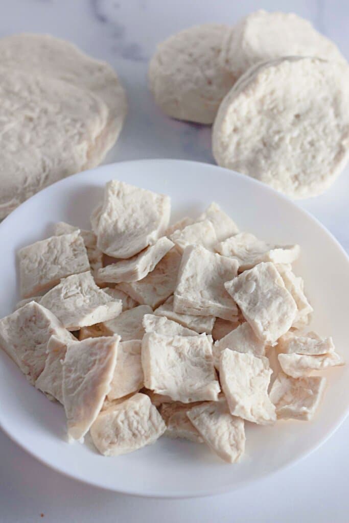 Pieces of biscuit dough on a white plate.