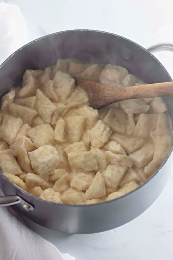 Biscuit dough being cooked in a pot.