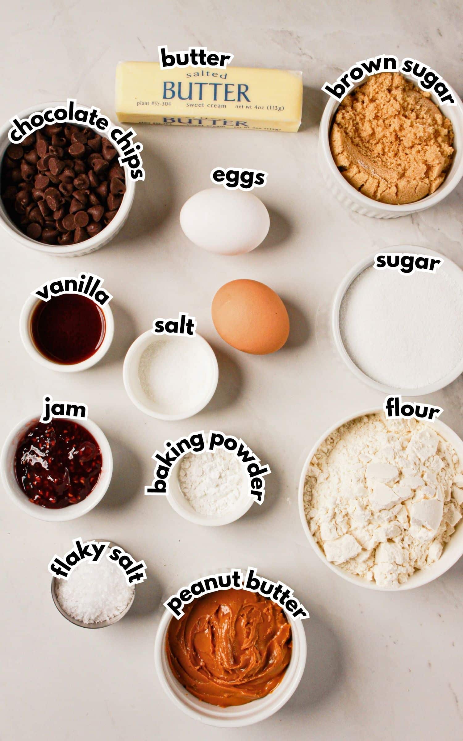 Bowls of ingredients labelled with text on a counter.