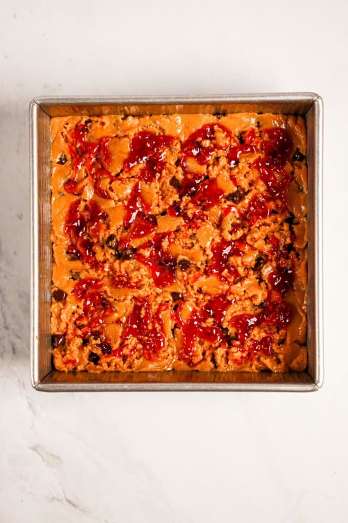 Jam being swirled into batter.