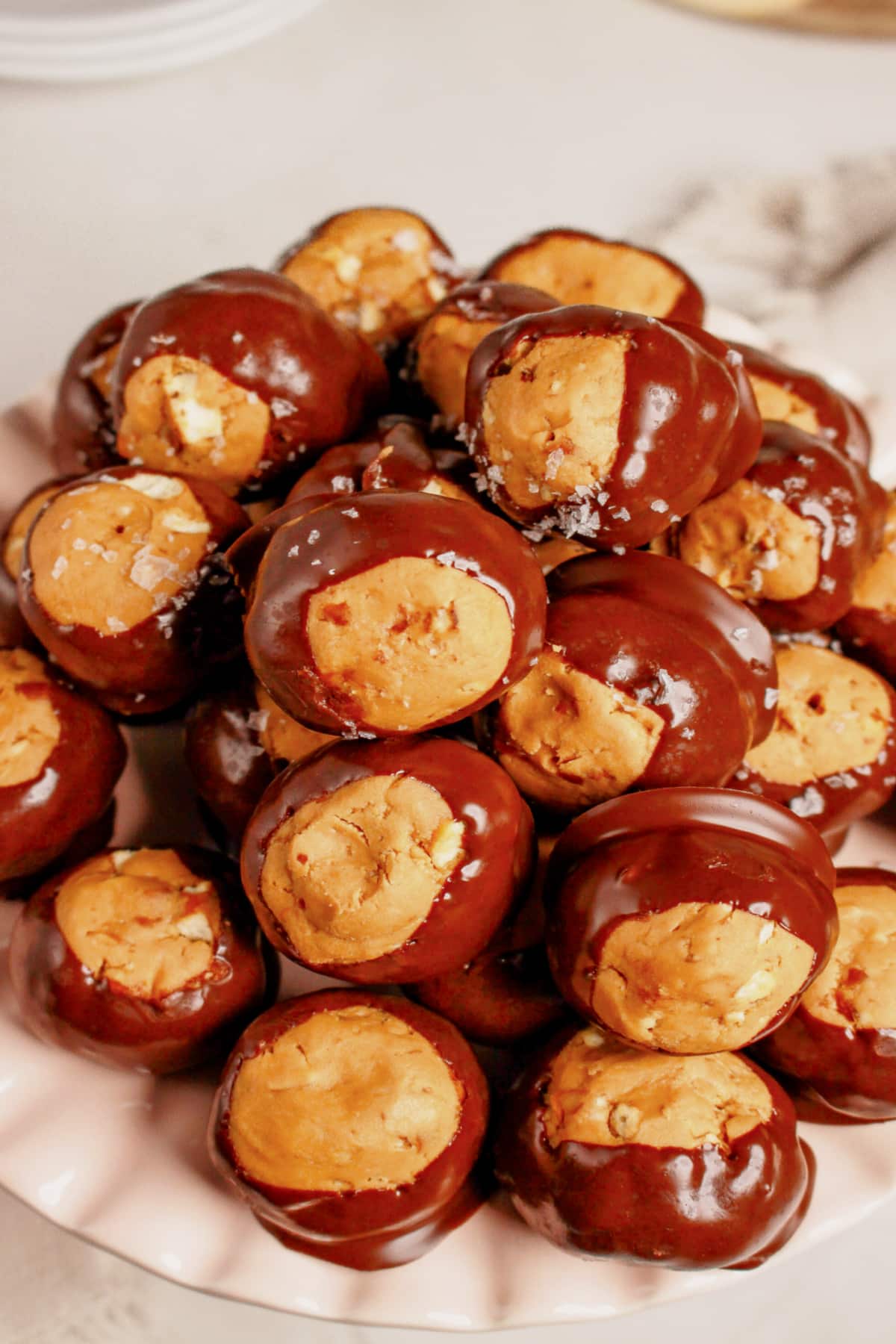 Pretzel buckeyes stacked in a pyramid on a plate.