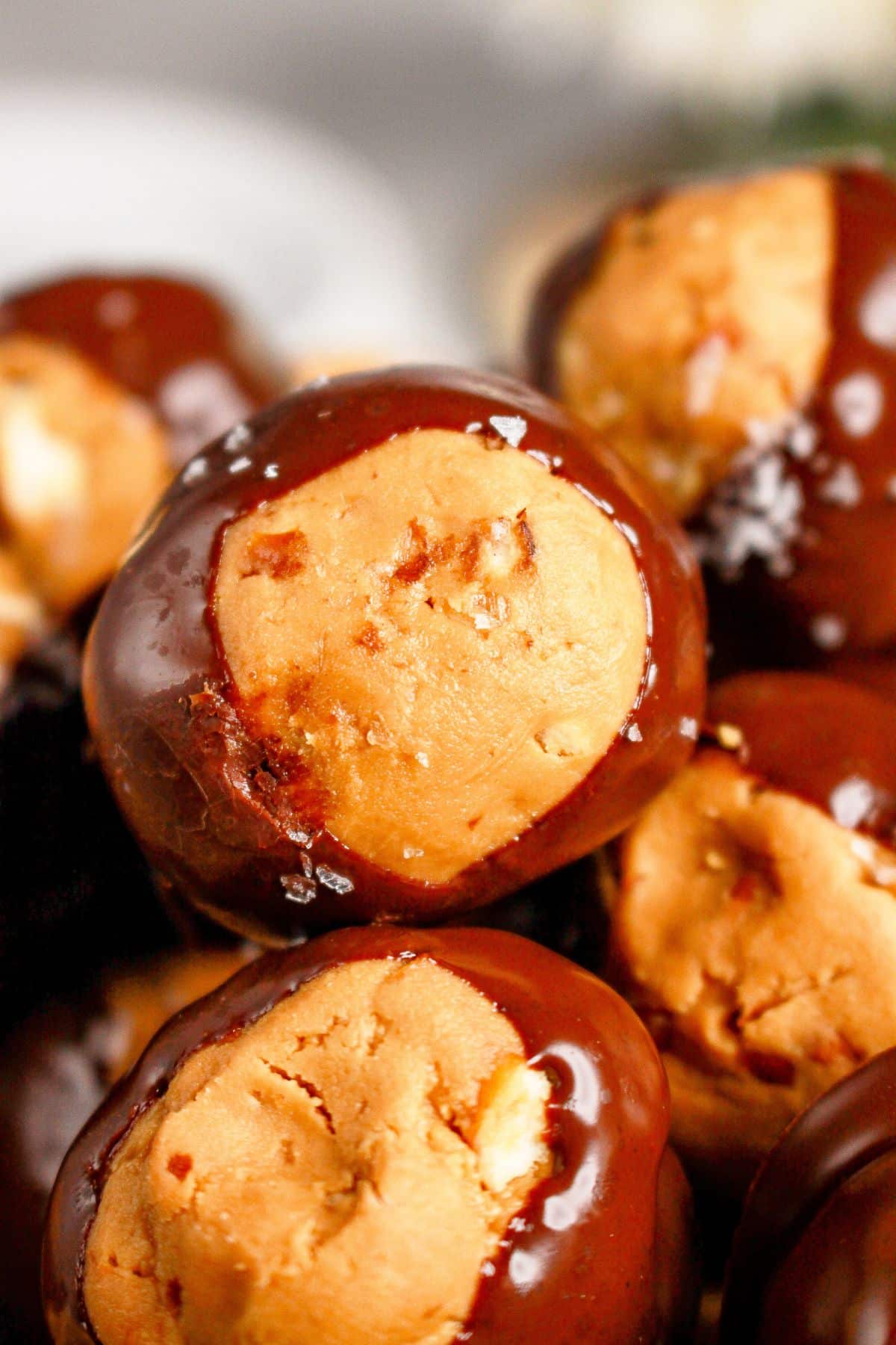 Pretzel buckeyes stacked in a pyramid on a plate.