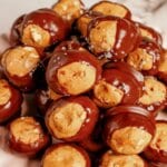 Pretzel Buckeyes Pretzel buckeyes stacked in a pyramid on a plate.