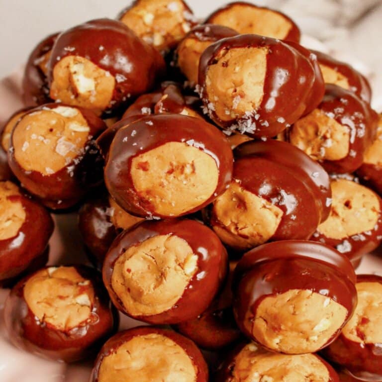 Pretzel buckeyes stacked in a pyramid on a plate.