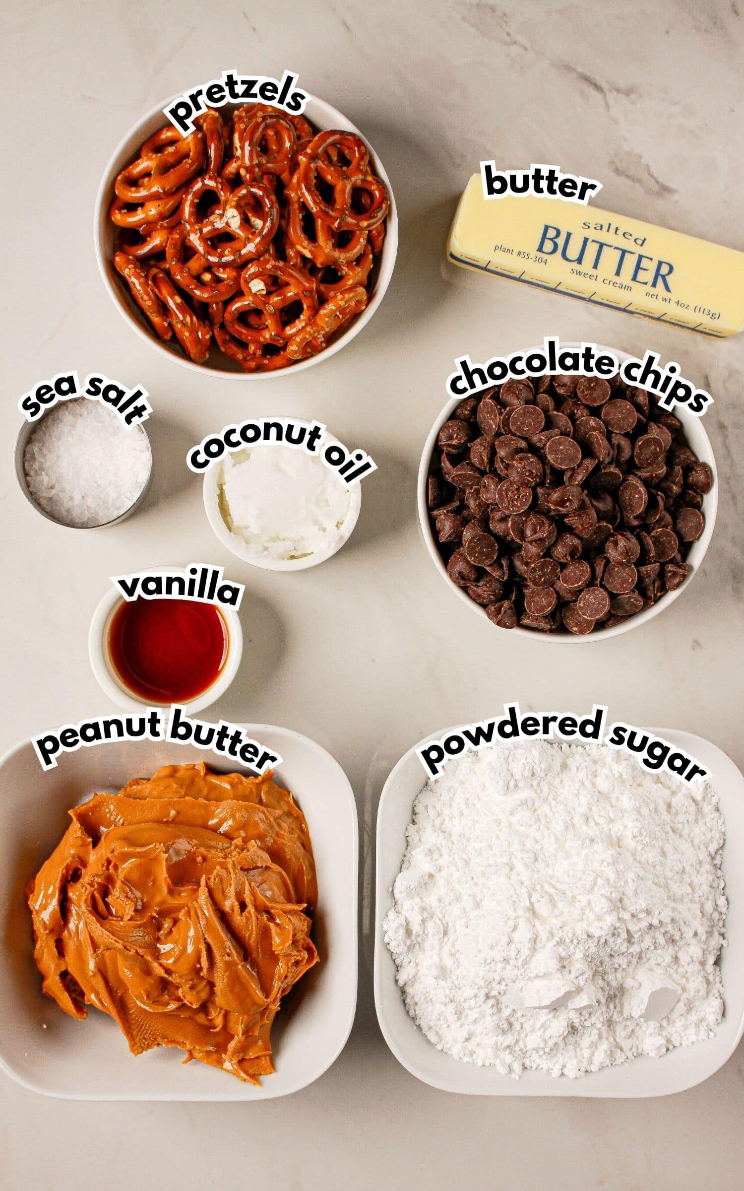 Bowls of ingredients labelled with text on a counter.