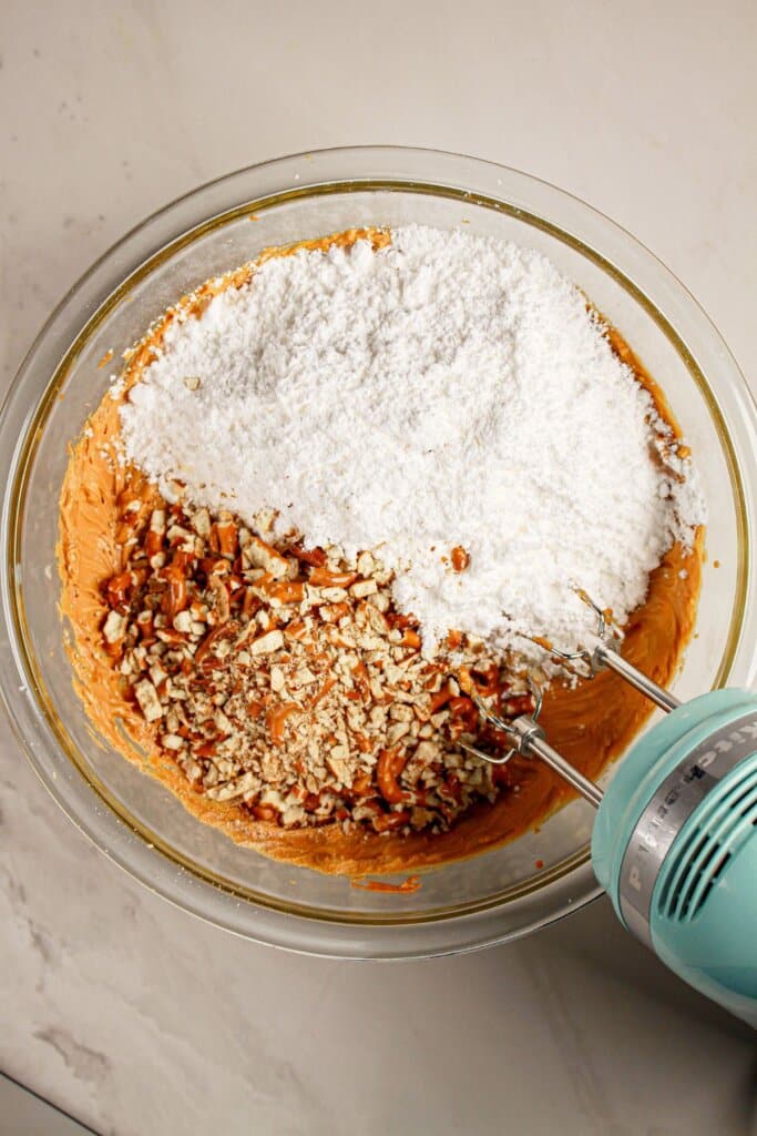 Ingredients being mixed together in a glass mixing bowl.