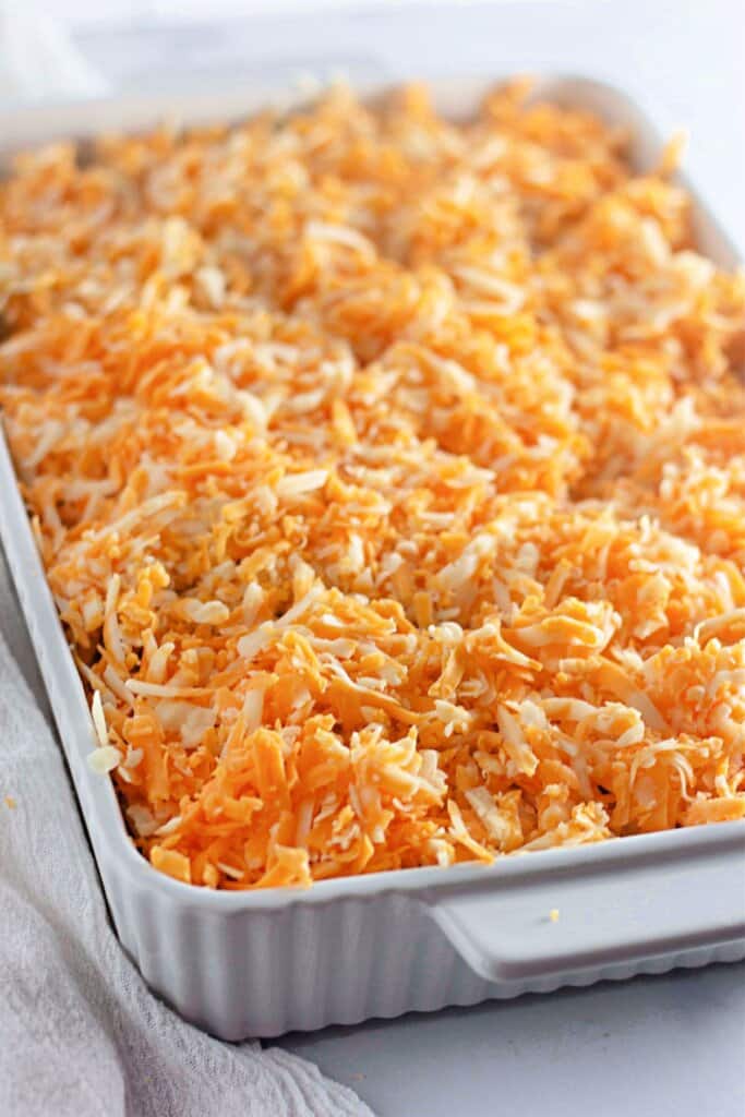 Shredded cheddar sprinkled on top of casserole.