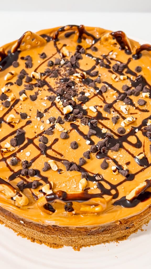adding toppings to baked cheesecake.