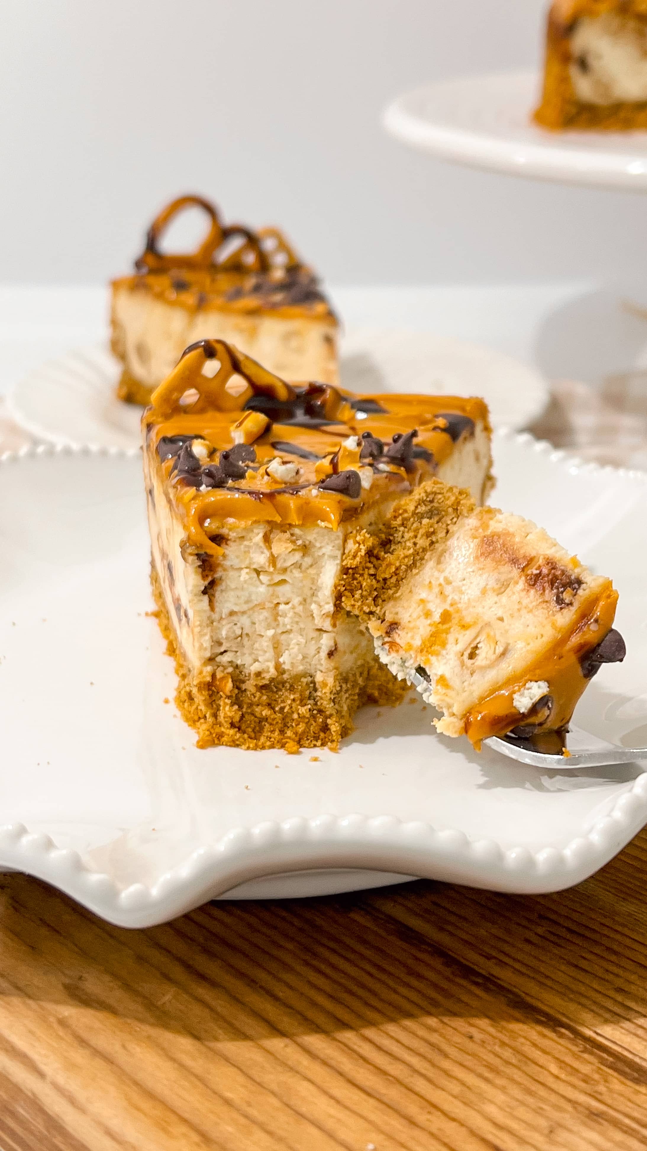 A slice of cheesecake with a bite being taken.