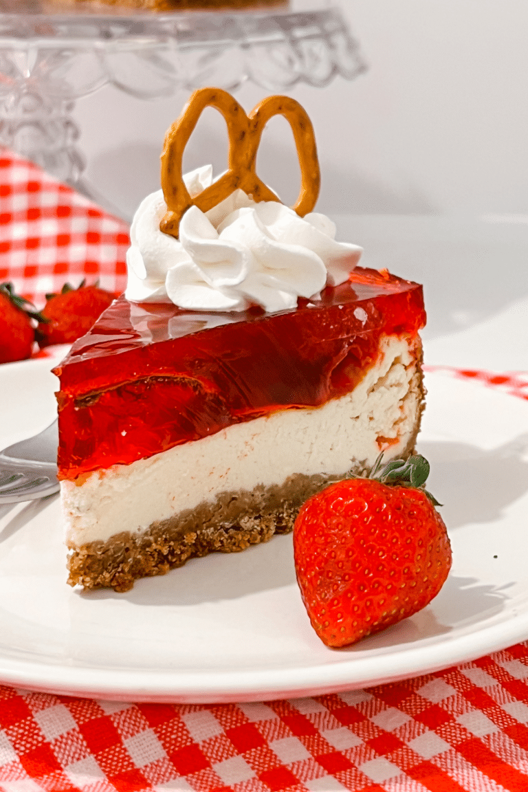 Slice of strawberry pretzel salad cheesecake recipe on a white plate.
