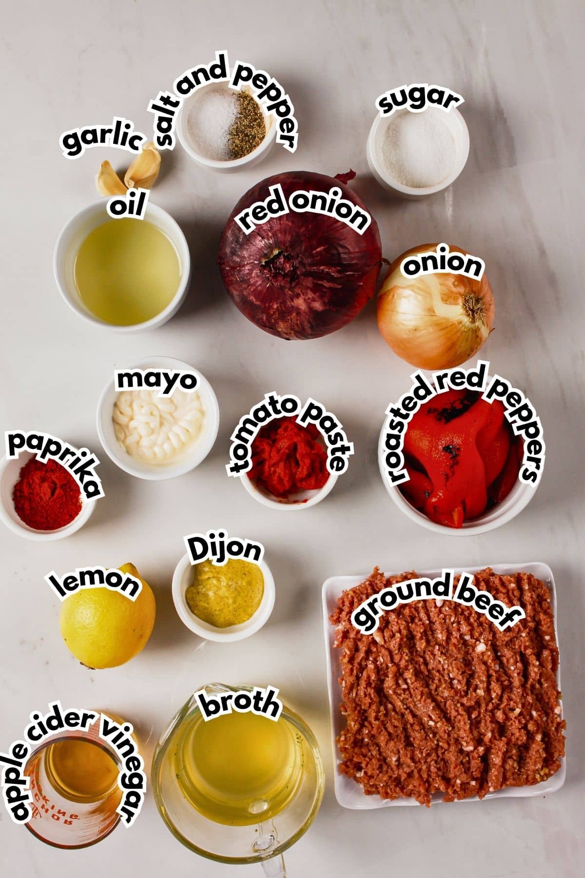 Bowls of ingredients labelled with text on a counter.