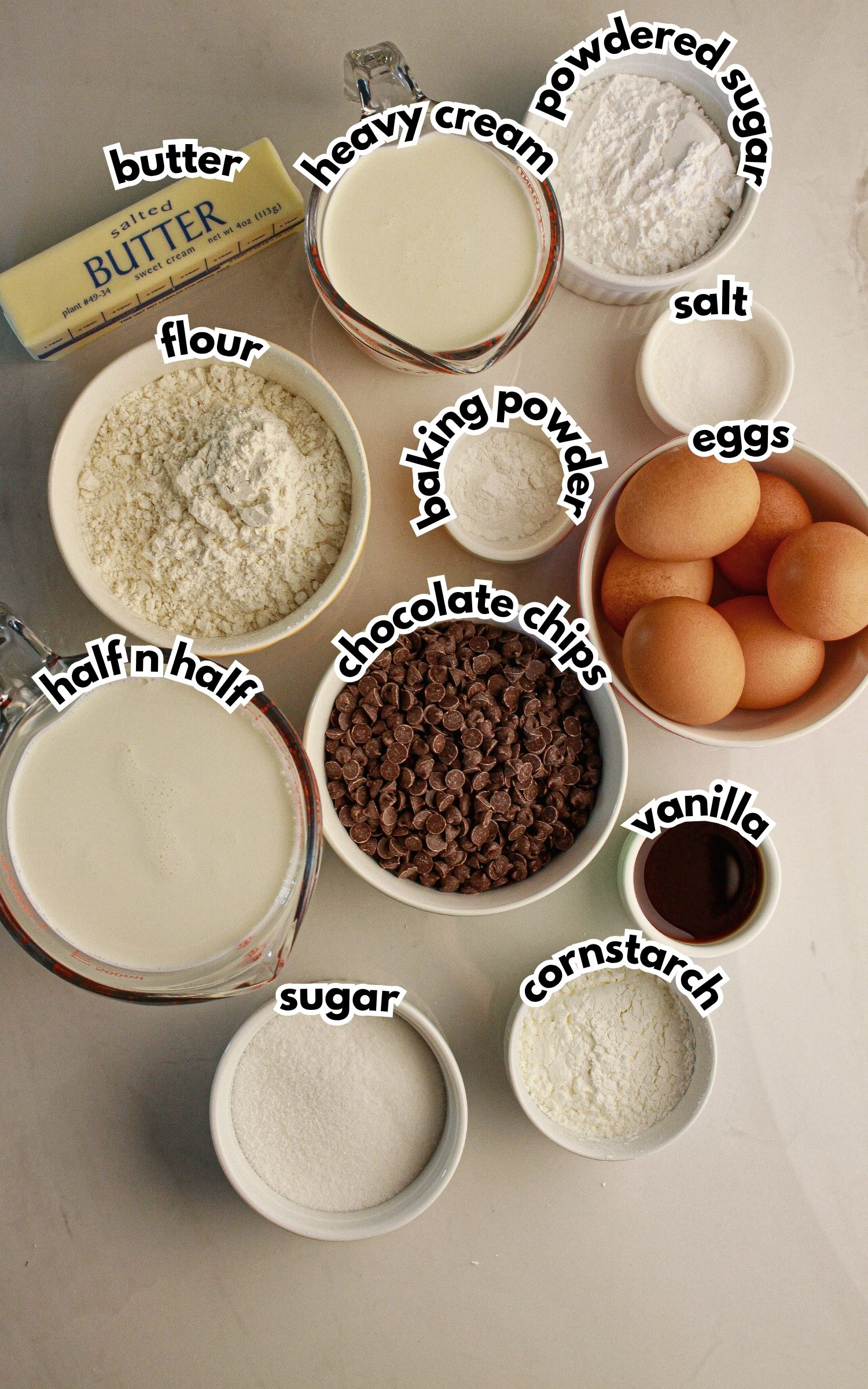 Bowls of ingredients labeled with text on a counter.