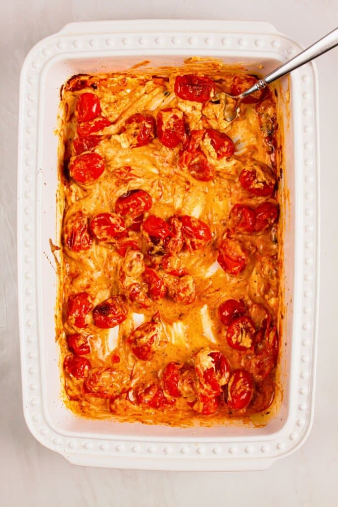 Sauce being mixed in a baking dish.