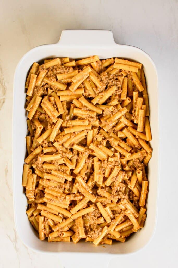 Cooked beef and noodles in a casserole dish.