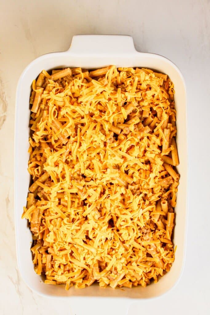 Cheddar sprinkled on top of a casserole dish.