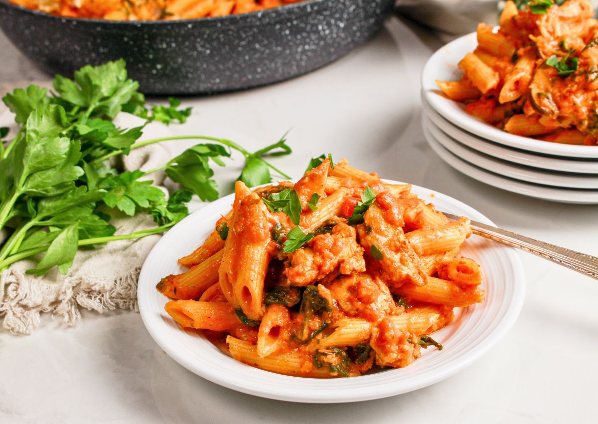 Serving of chicken parmesan pasta skillet on a small plate.