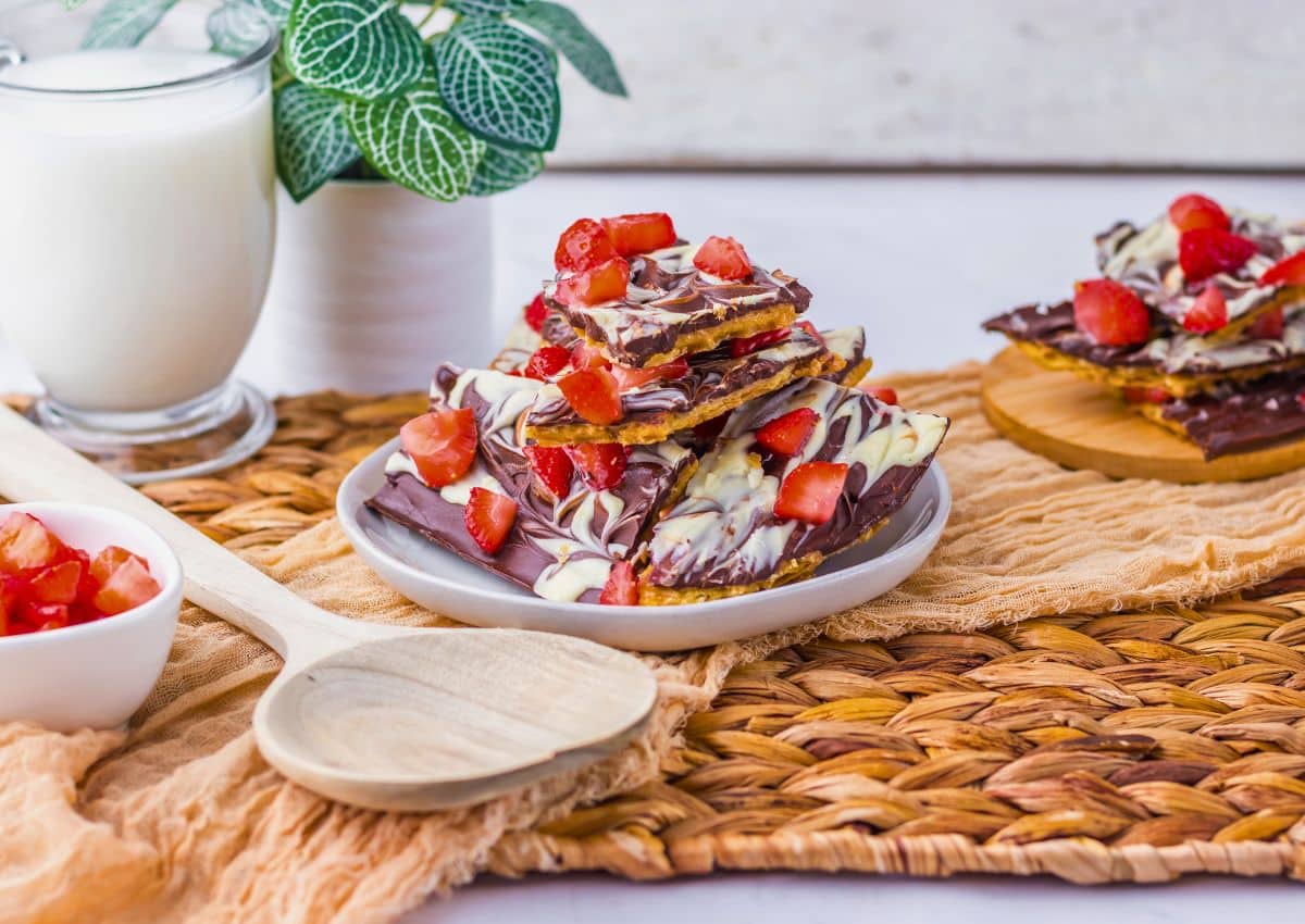 Stack of chocolate covered strawberry bark on a plate.