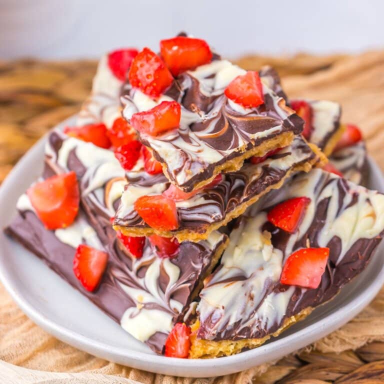 Stack of chocolate covered strawberry bark on a plate.