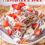 Chocolate covered strawberry bark on a plate.