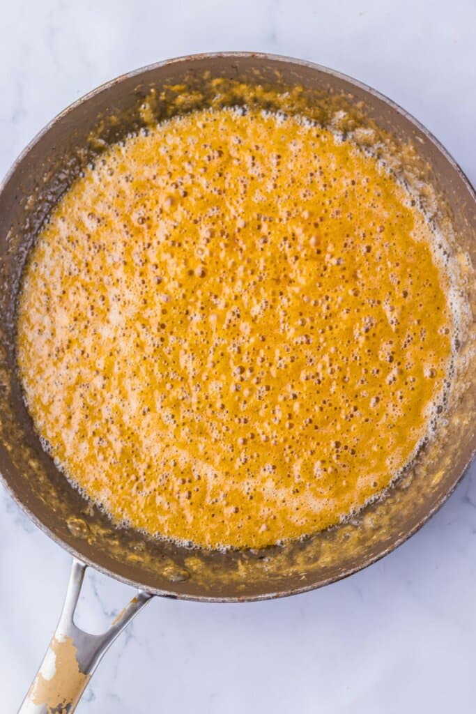 Toffee being made in a skillet.