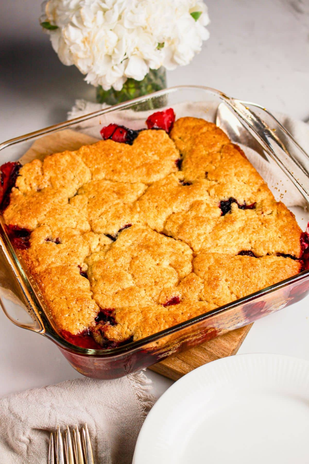 Finished cobbler in a glass baking dish.