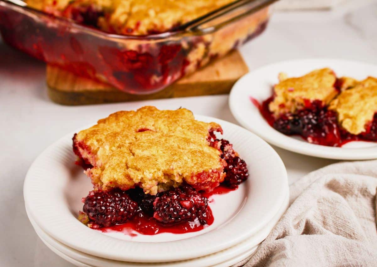 Slice of blackberry cobbler on a small plate.