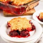 Slice of blackberry cobbler on a small plate.