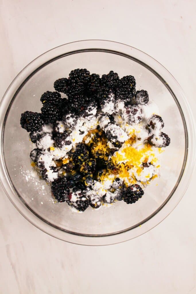 Fruit being tossed in sugar and cornstarch.