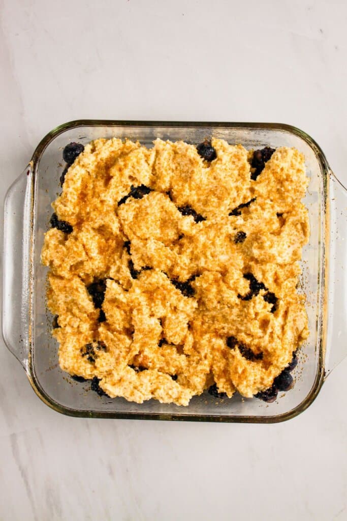 Topping being added to the top of the dessert.
