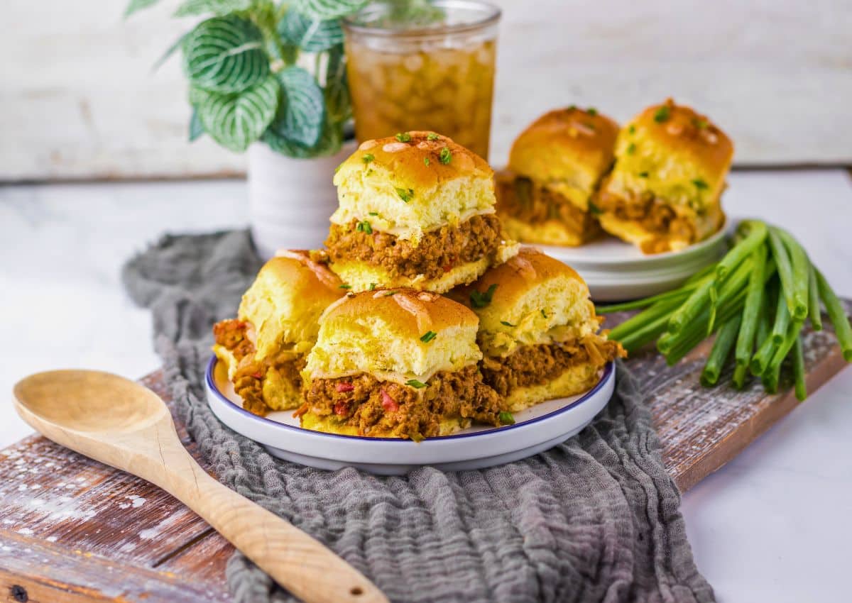 Enchilada sliders stacked on a plate.