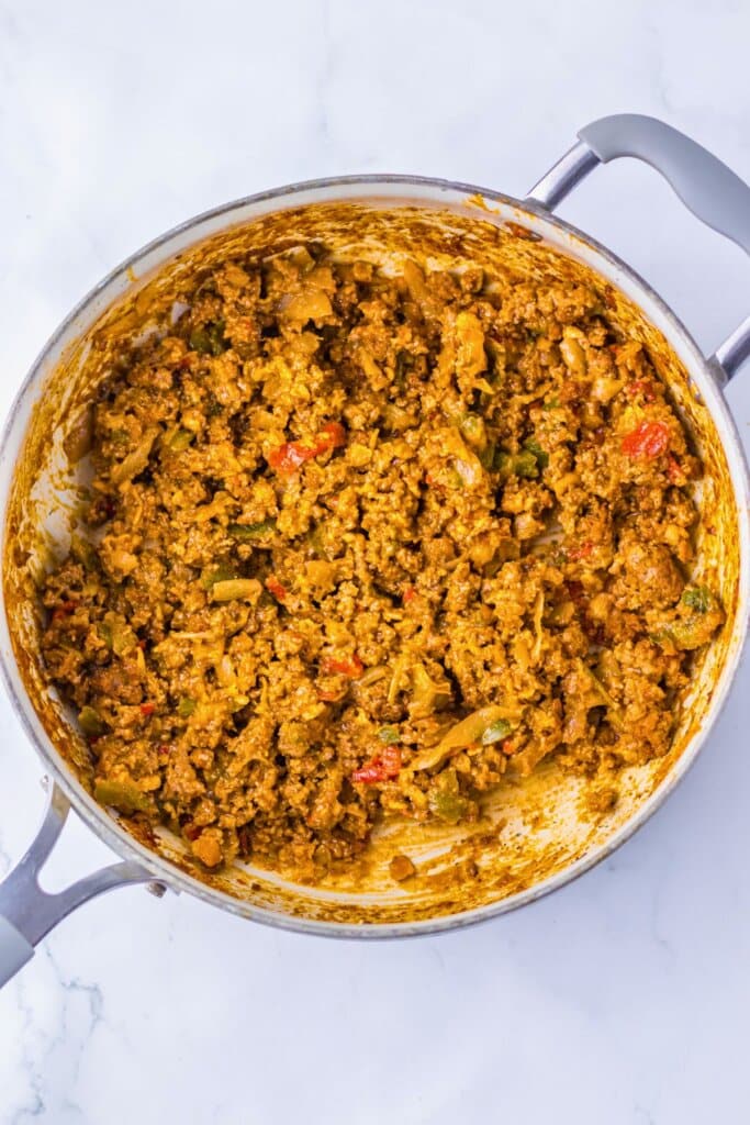 Meat and veggies in a skillet.