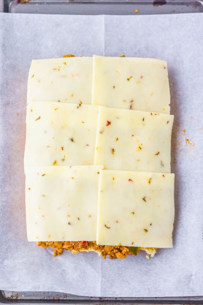 Cheese on top of sandwiches.