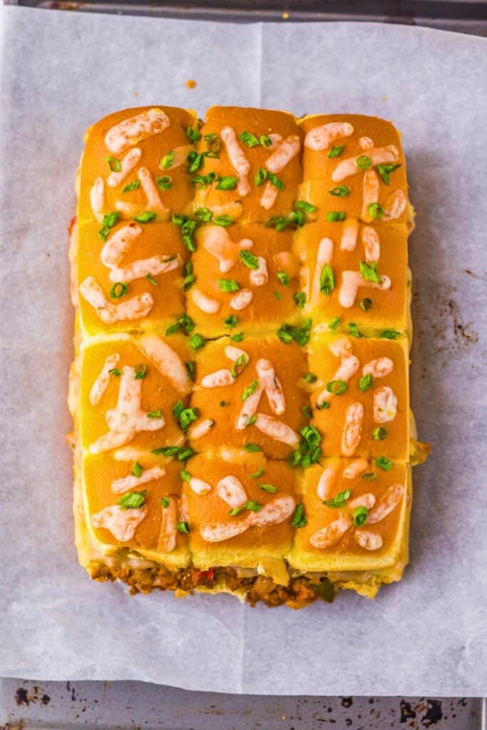 Baked sandwiches on a baking sheet.