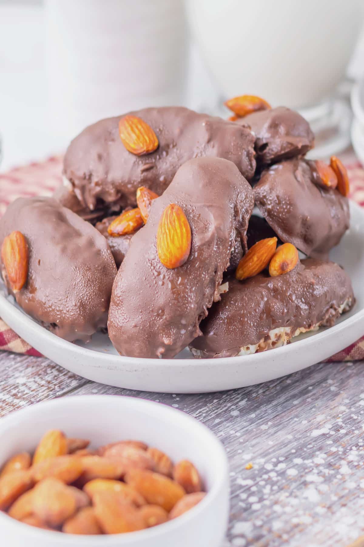 Homemade almond joys stacked on a plate.