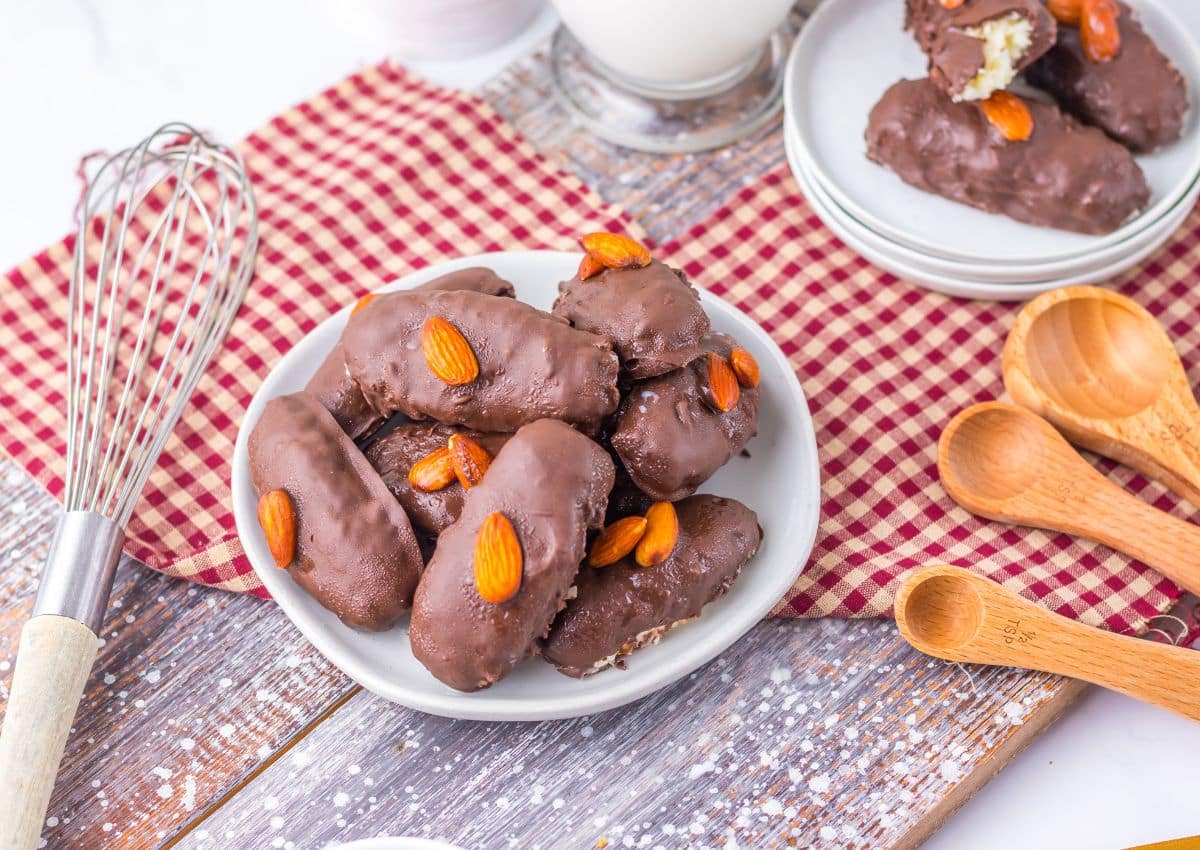 Homemade almond joys stacked on a plate.