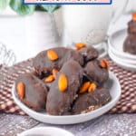 Homemade almond joys stacked on a plate.
