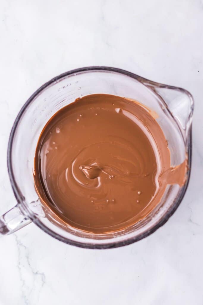 Melted chocolate in a glass bowl.