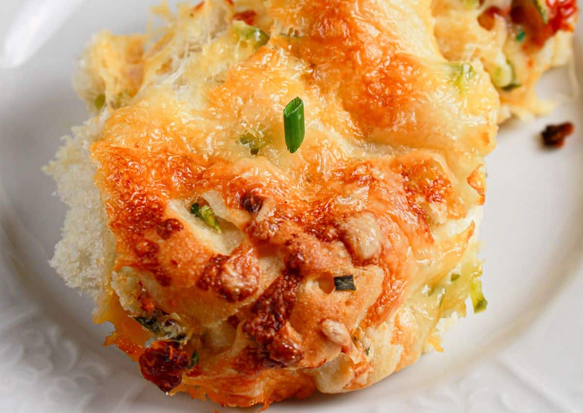 Jalapeno cheddar pull apart bread on a small plate.
