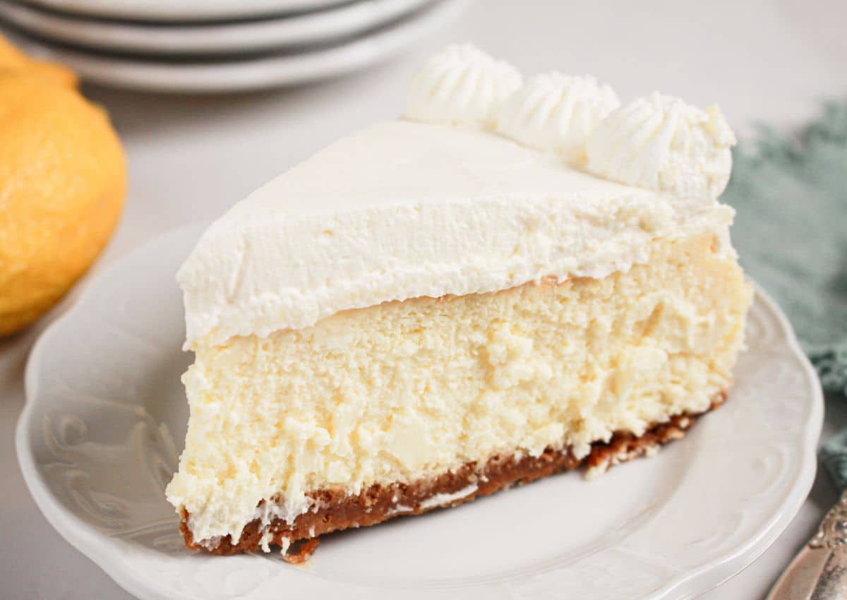 Slice of lemon cheesecake on a plate.