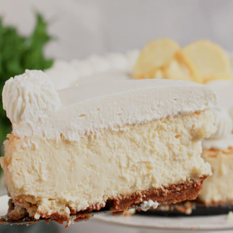 Slice of lemon cheesecake on a plate.