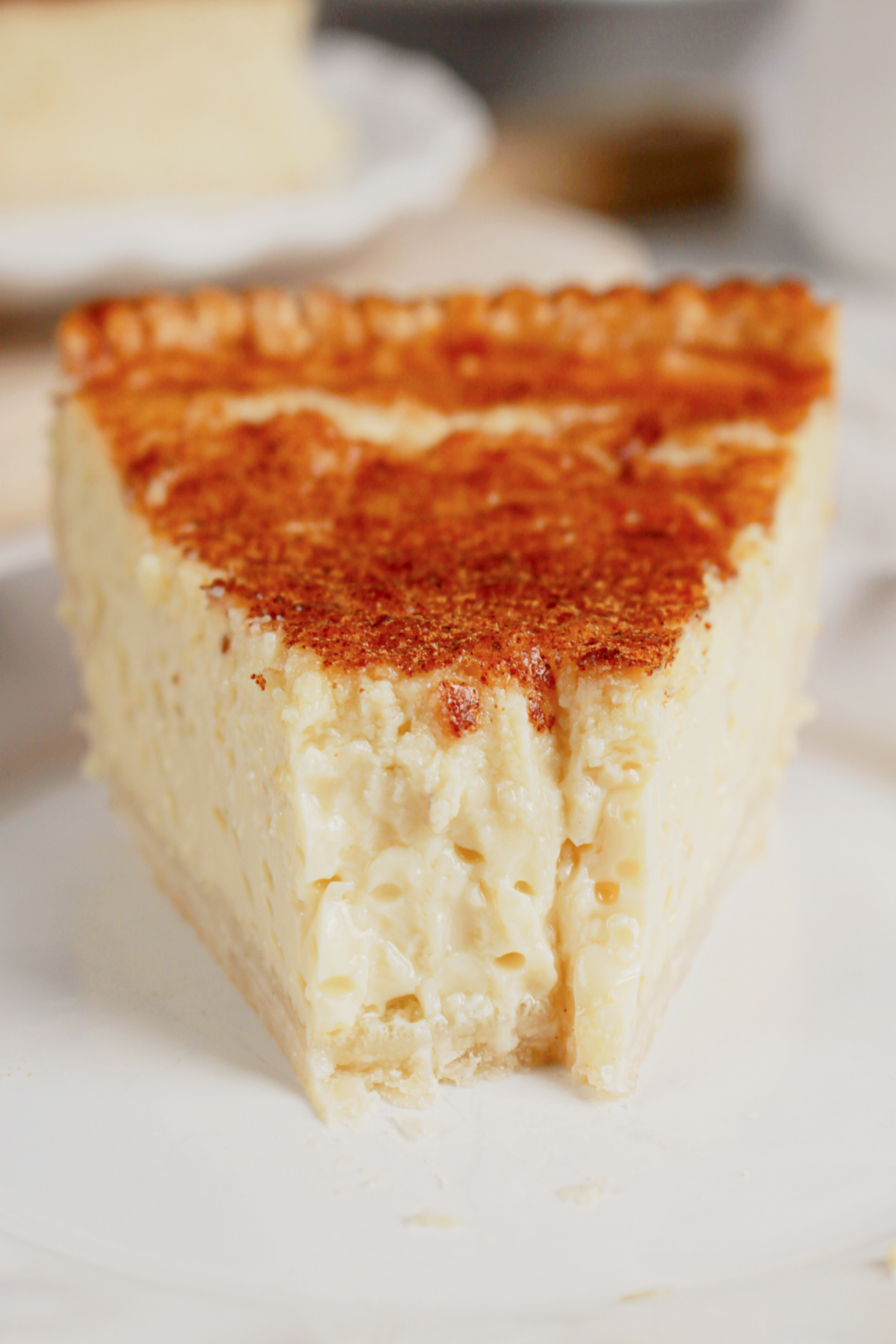Slice of lemon custard pie on a small plate.