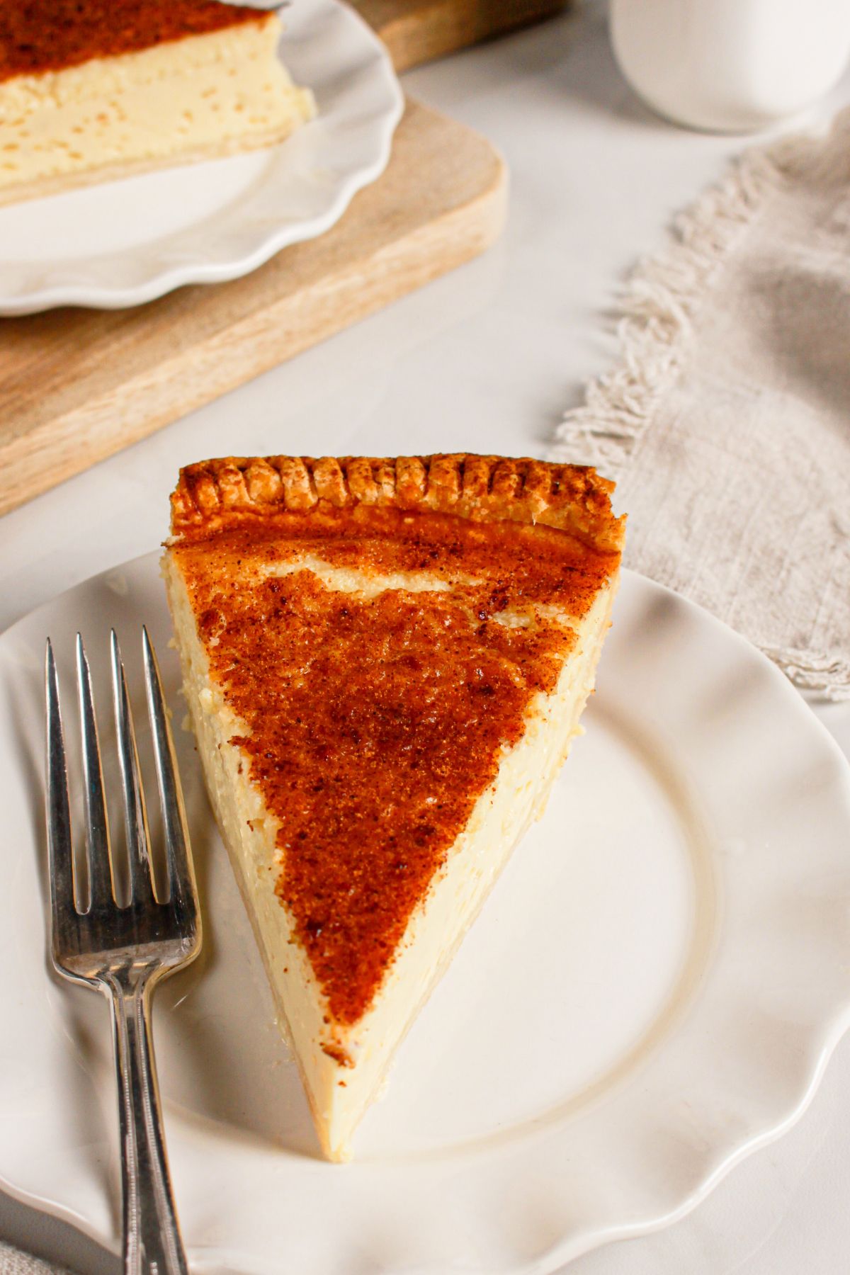 Slice of lemon custard pie on a small plate.