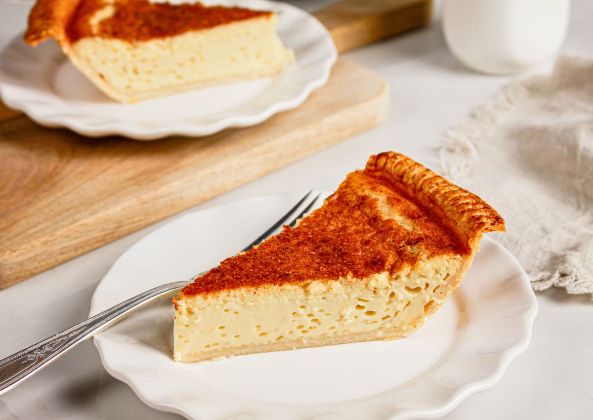 Slice of lemon custard pie on a small plate.