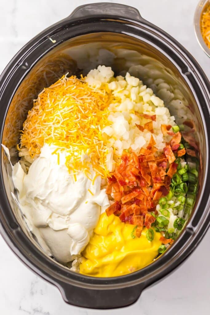 Ingredients being mixed in a crockpot.