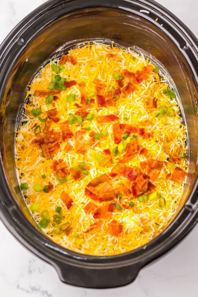 Shredded cheese on top of a crockpot.