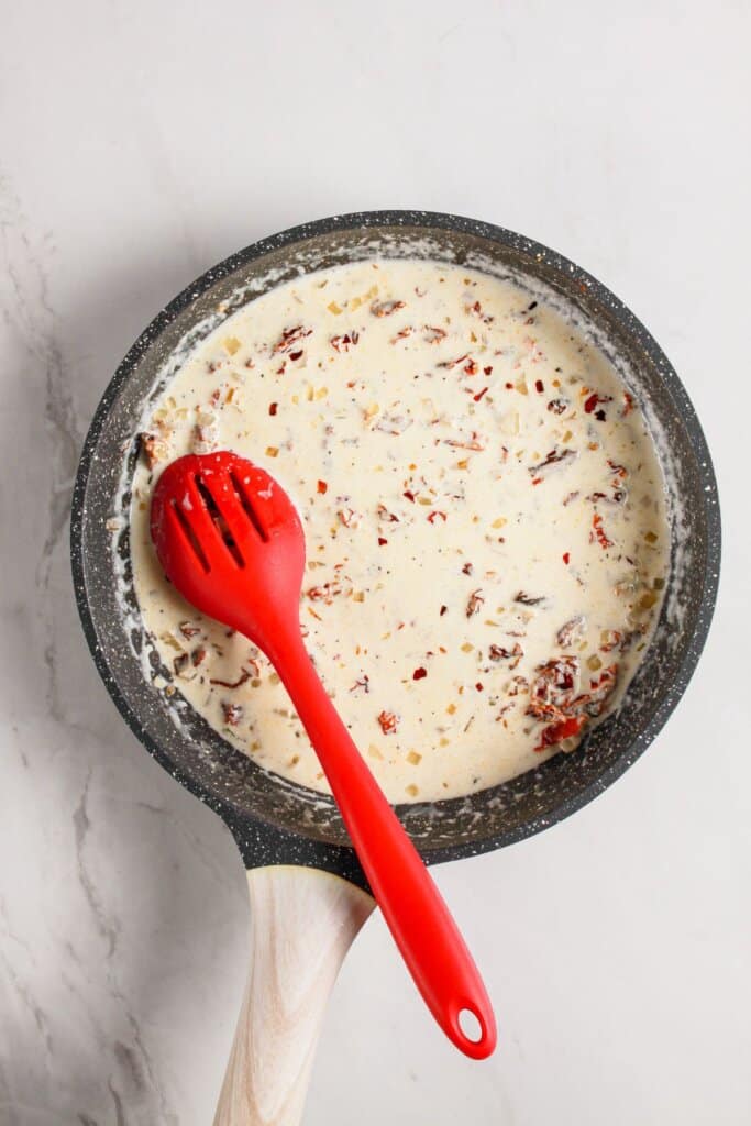 Cream being added to skillet.