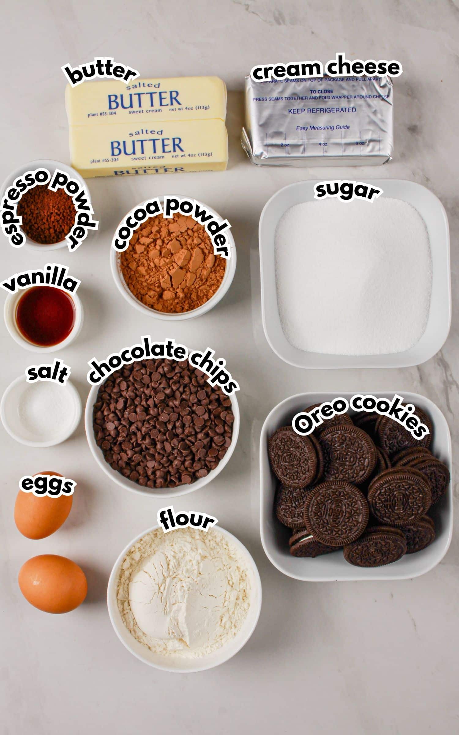 Bowls of ingredients labelled with text on a counter.