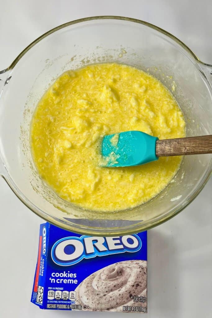 Wet ingredients being mixed in a glass bowl.
