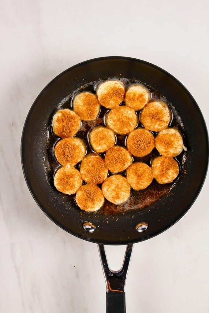 Fruit being cooked in a skillet.