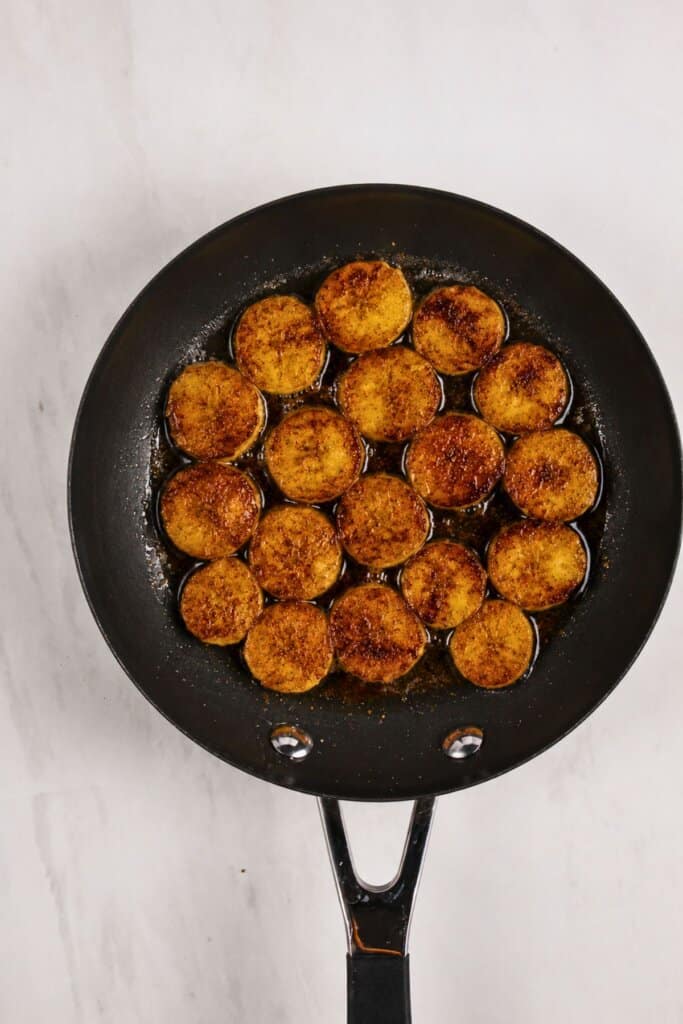 Browned fruit in a skillet.